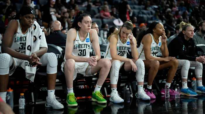 New York Liberty players Jonquel Jones, Breanna Stewart and Sabrina Ionescu sit on the bench as they trail the Las Vegas Aces in Game 2 of the WNBA Finals.